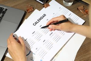 person circling a date on the calendar for when he needs shredding