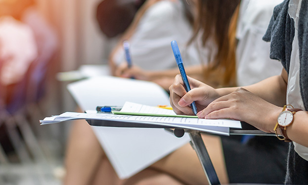 A student sitting at a desk taking notes