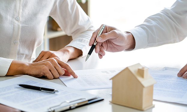 Two people reviewing insurance documents at a desk
