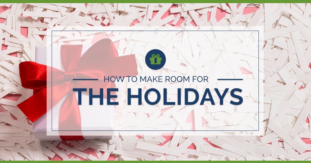 red holiday bow on a white box laying on top of a pile of shredded documents